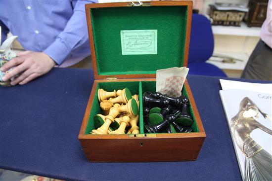 A Jaques & Son Staunton boxwood and ebony chess set, kings 4.25in., board 22 x 21.75in.